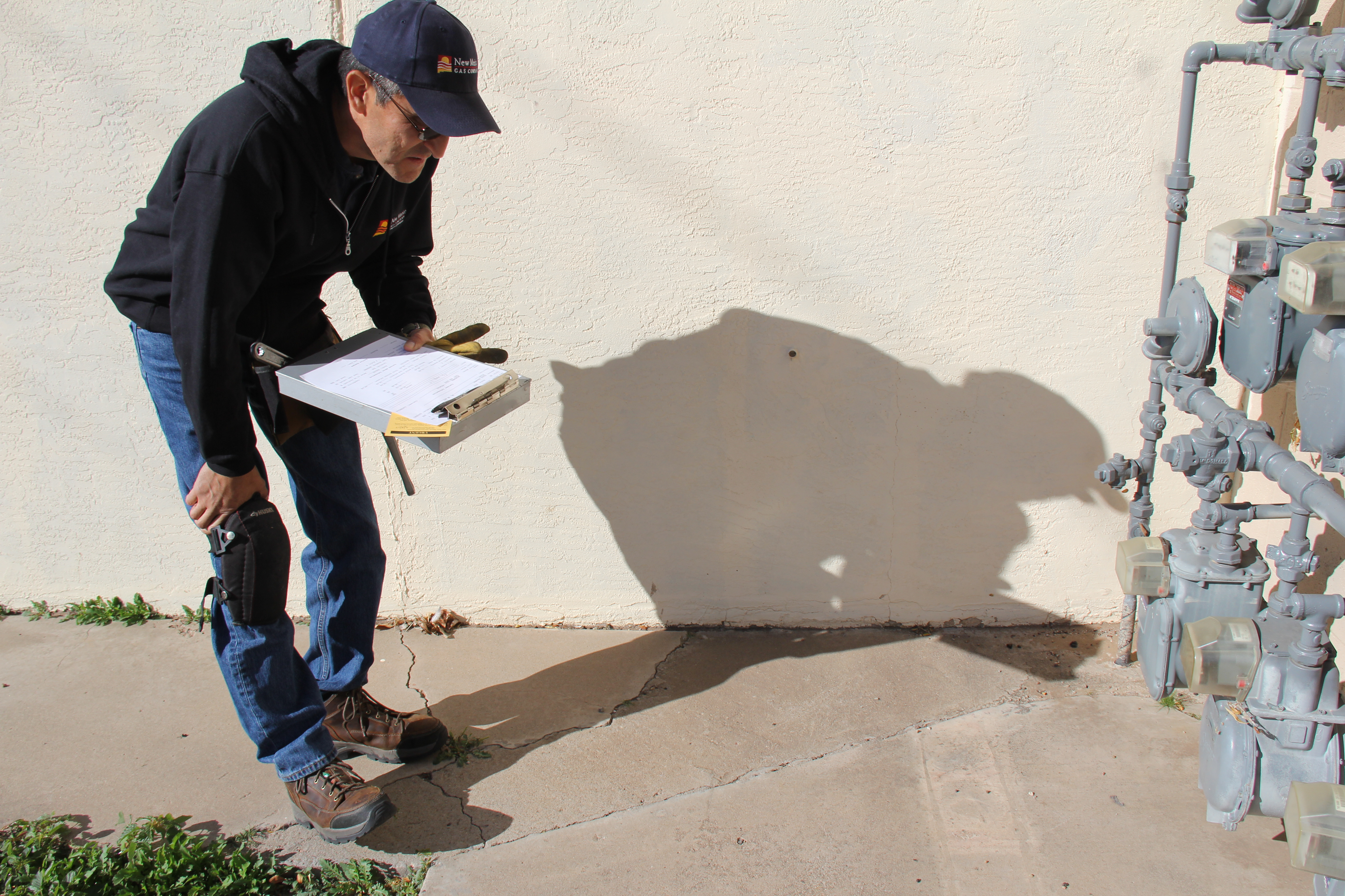 NMGC Collector checking a natural gas meter status.